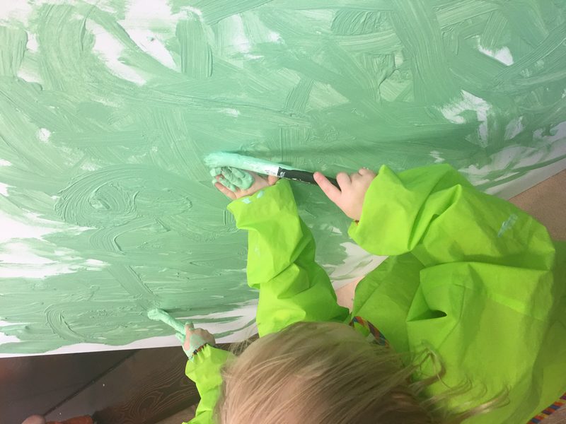Child engaged in creative expression through painting