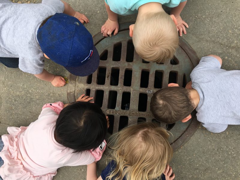 Children gathered together, exploring with curiosity